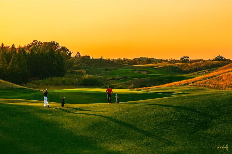 E101--Players 077  V1  1200px  SS  with signature.jpg :: Players hit thier approach shots to the par four 2nd green (with the third hole beyond) at Erin Hills, a daily fee destination golf course and resort in Erin, Wisconsin and site of the 2017 US Open Championship.  The course was designed by Hurdzan/Fry and Ron Whitten and built by Landscapes Unlimited, LLC.  It opened for play in 2006 and has already hosted the 2011 US Amateur Chanpionship and the 2008 Women's Amateur Public Links.  Photograph and copyright by Paul Hundley, September, 2014.