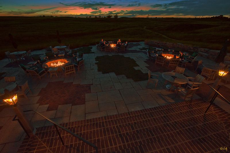 E101--Terrace 026  V1  1200px  SS.jpg :: Guests enjoy food and drinks on the outdoor terrace off The Lodge at Erin Hills.  The terrace features sample seating and 3 firepits, and is open daily after 3 PM.  Erin Hills is a daily fee golf course in Erin, Wisconsin.  Erin Hills was designed by Hurdzan/Fry and Ron Whitten and built by Landscapes Unlimited, LLC, and has been choosen to host the 2011 US Amateur Chanpionship and the 2017 US Open Championship.  Photo by Paul Hundley; taken in September, 2013.