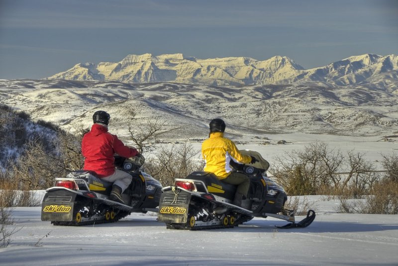 GBL-UTM-9.jpg :: Man and woman on snowmobiles overlooking Timpanogas Peak. Wasatch Mountains. Utah. USA.