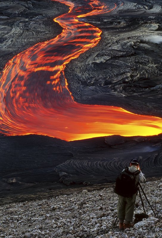GBL-VLF-38.jpg :: Stream of pahoehoe lava flowing in a rocky landscape with a photographer capturing the moment in the foreground