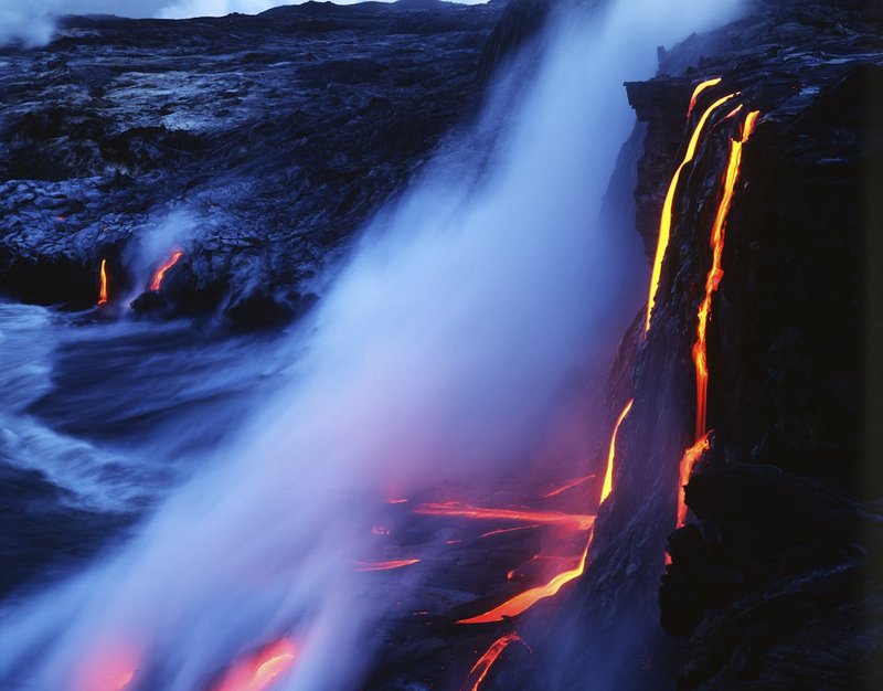 GBL-VLO-9.jpg :: Vibrat bright lava flows in tiny strands from a rocky shore in Hawaii National Park into the sea in a misty morning